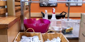 Buffet area with baskets of utensils in a recovery support organization