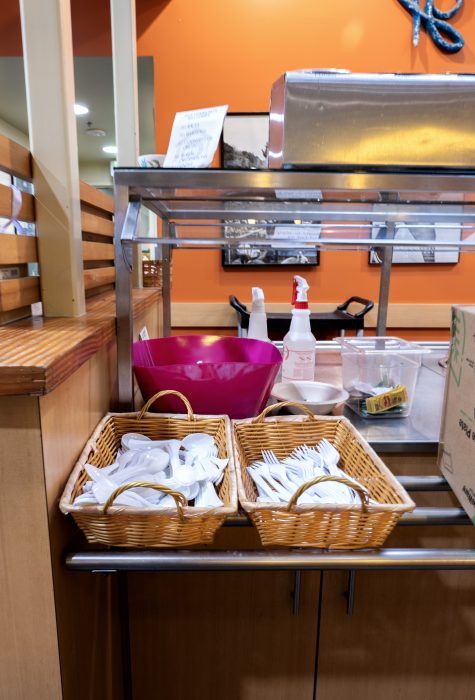 Buffet area with baskets of utensils in a recovery support organization
