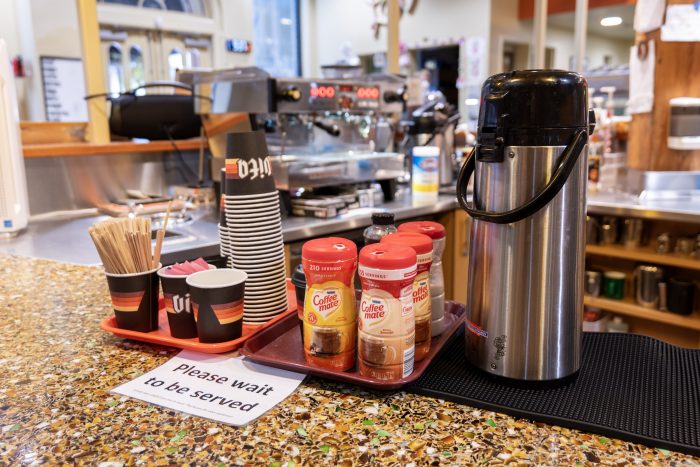 Coffee area with urns, cups, and creamers in a recovery support organization