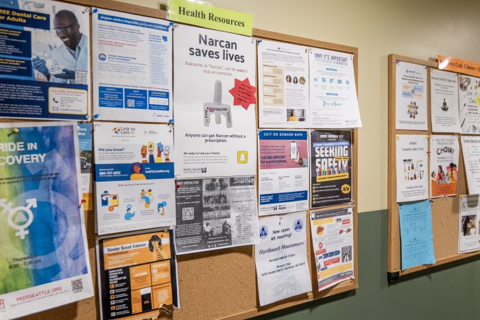 Bulletin boards on the wall of a recovery support organization with health resources and classes and events