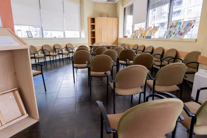 An empty classroom in a recovery support organization with chairs and bright windows