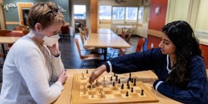 Two people playing chess in a recovery support organization’s community space