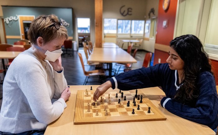 Two people playing chess in a recovery support organization’s community space