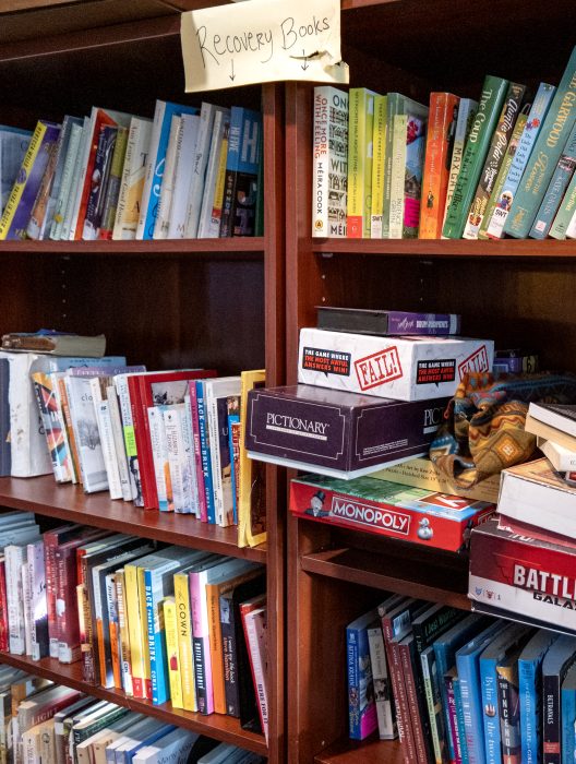 Shelf of books and games in a recovery support organization