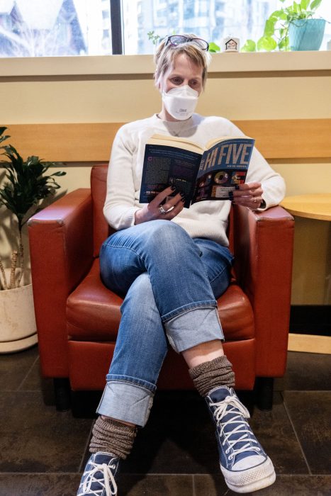 Recovery support organization visitor reads in a chair