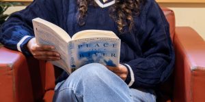 Recovery support organization visitor reads in a chair