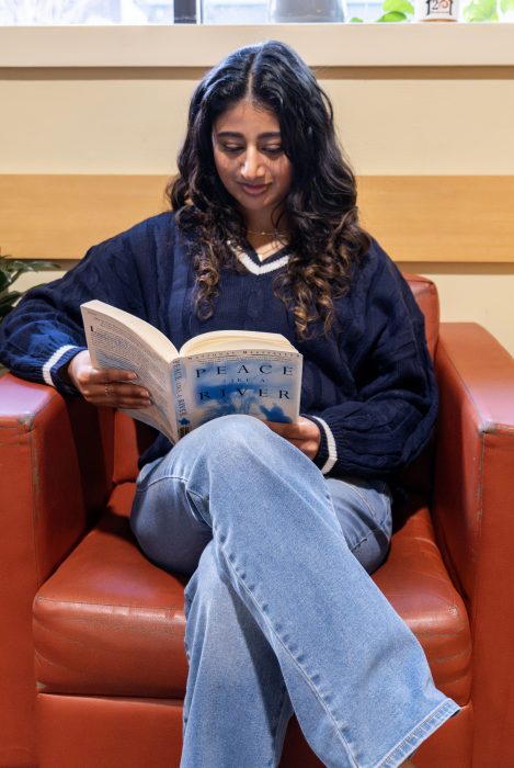 Recovery support organization visitor reads in a chair