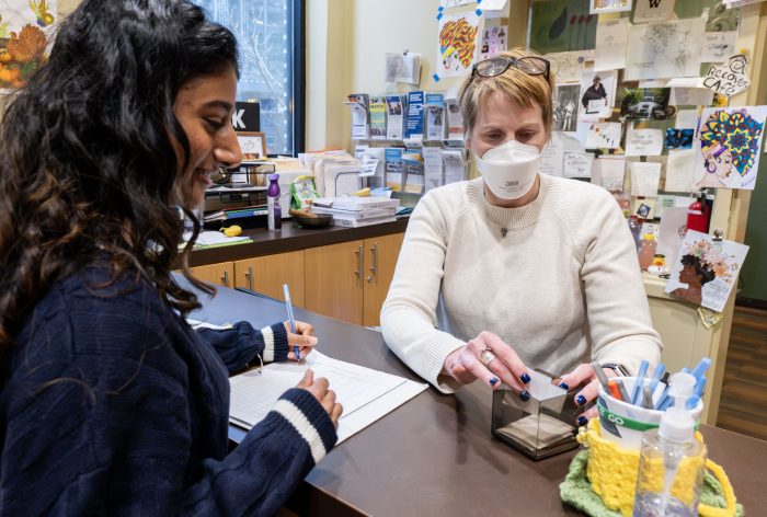 Person checking in at the front desk of a recovery support organization
