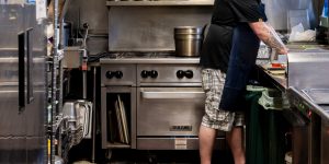A chef working in the kitchen of a recovery services organization