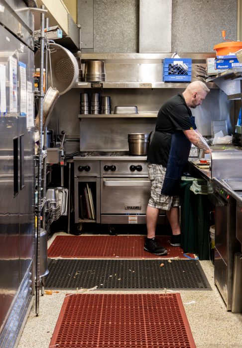 A chef working in the kitchen of a recovery services organization